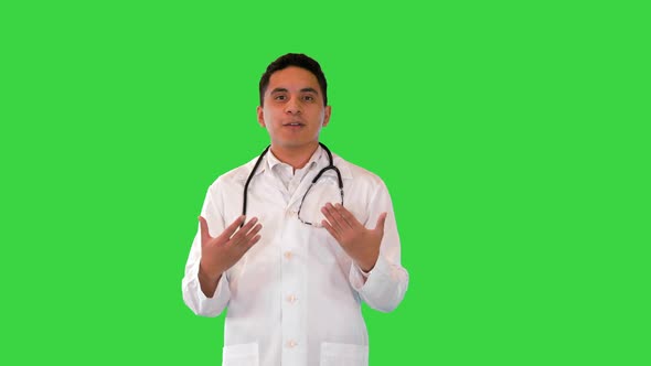 Hispanic Male Doctor Talking on Camera While Walking on a Green Screen Chroma Key