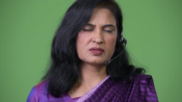 Close Up Shot of Mature Beautiful Indian Woman As Call Center Representative Talking on Headset