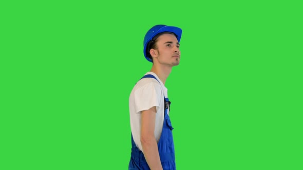 Walking Construction Worker in a Helmet on a Green Screen Chroma Key