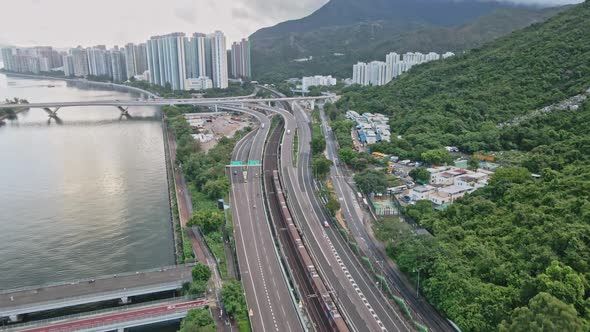 Drone shot of MTR Train and Highway traffic in Shatin, Hong Kong