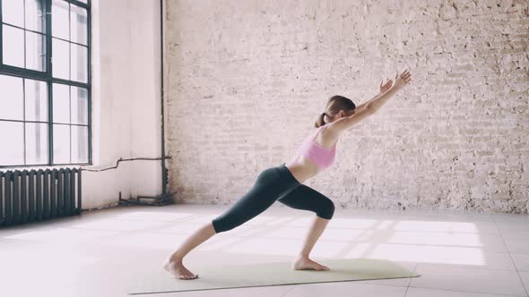 Beautiful Yoga Girl Doing Asanas in Studio