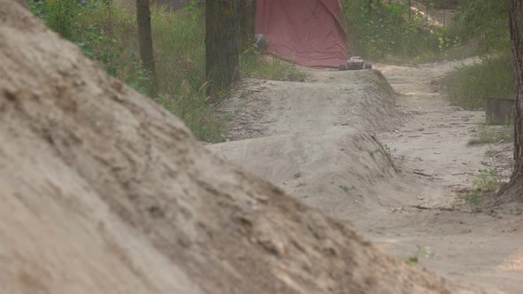 Radio Controlled Car Driving Over Sandy Hills