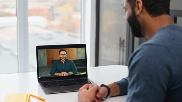 Two Indian Colleagues Speaking Through the Screen Using Laptop App for Virtual Connect