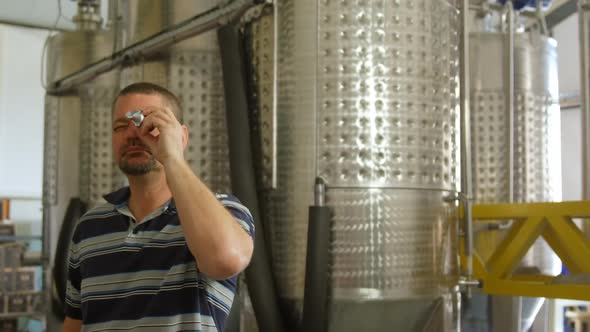 Male worker using magnifying glass