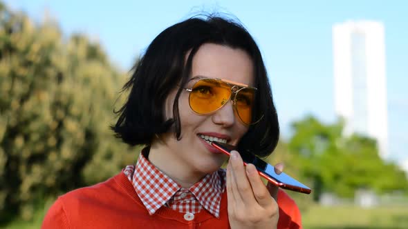 Beautiful and Happy Hipster Girl Talking on the Phone