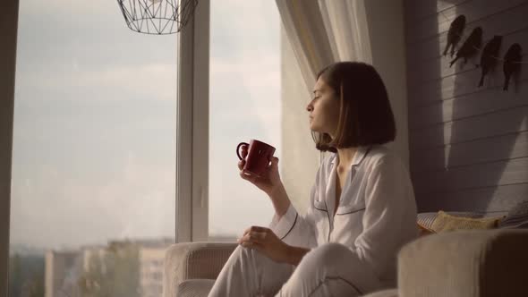 Young Female Relish Drink and Calm at Home