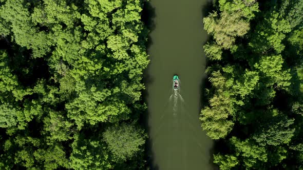 A drone flight over a motor boat in a river 