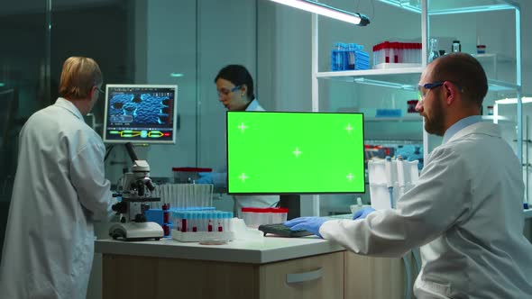 Scientist Man Typing on Computer with Green Mockup