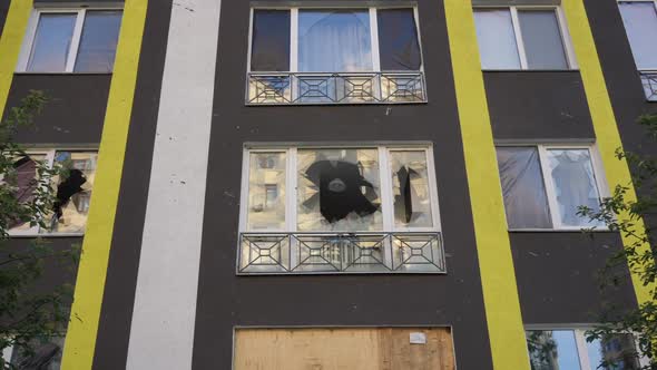 Broken Window in Residential House with Chandelier Hanging on Ceiling