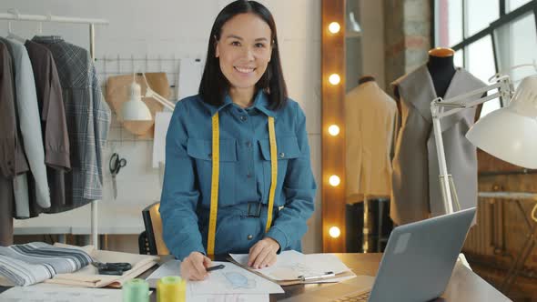 Slow Motion Portrait of Beautiful Asian Lady Standing in Workshop Smiling