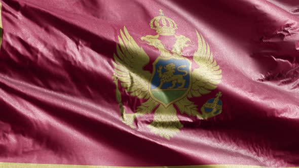 Montenegro textile flag waving on the wind. 10 seconds loop.