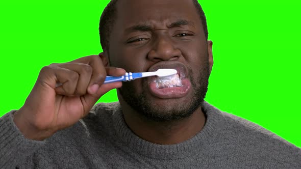 Dark-skinned Man Brushing His Teeth.