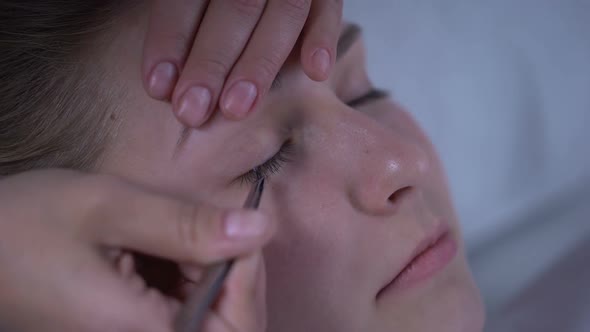 Master of Eyelash Extensions Adding Volume to Womans Lashes, Beauty Salon