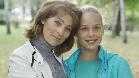 Portrait of Young-looking Caucasian Grandmother and Her Teenage Pretty Blond Granddaughter Looking