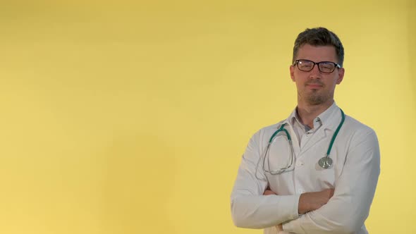 Cheerful Young Doctor in Lab Coat Nodding His Head Showing That He Is Agree with Something