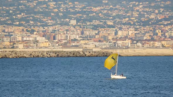 White Yacht with Yellow Sail Floating Near Gulf of Naples, Water Transportation