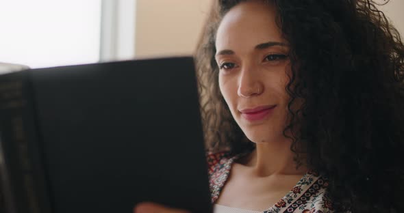 Beautiful smiling female reading a book