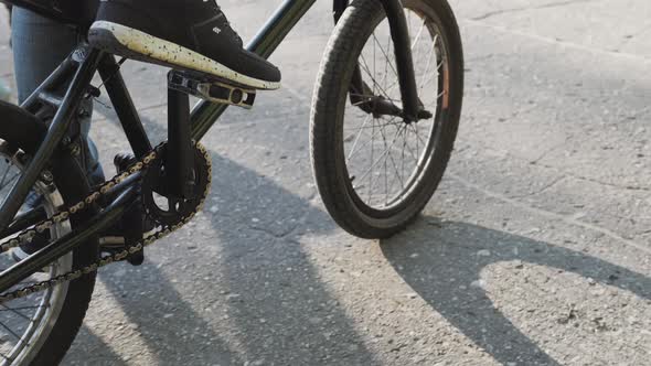 Person Riding a Bike Outdoors on a Walkway Alongside a Canal Close Up View of the Sole and Underside