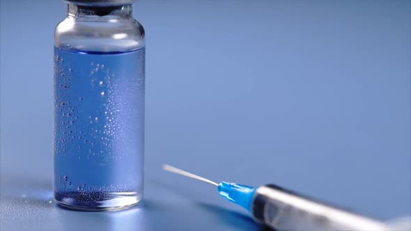 Close Up View of Ampoule and Syringe with Selective Focus.