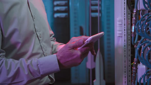 Male Data Center Technician Working in Server Room