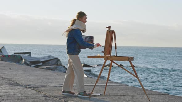 Young Excited Inspired Lady Artist Creating Masterpiece of Nature Drawing Seaside Picture on