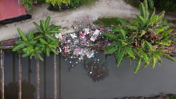 Aerial view illegal garbage dump near the river