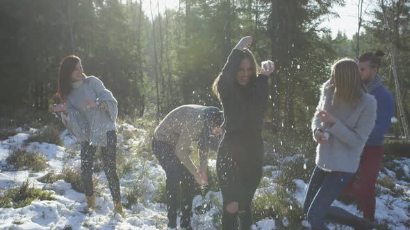 People playing with snow in the forest