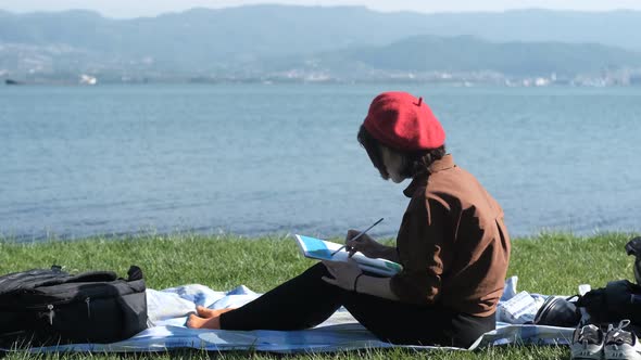 Women Drawing With Seascape