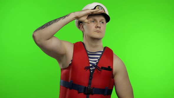 Young Muscular Sailor Man Works As Lifeguard at Beach Observe the Territory