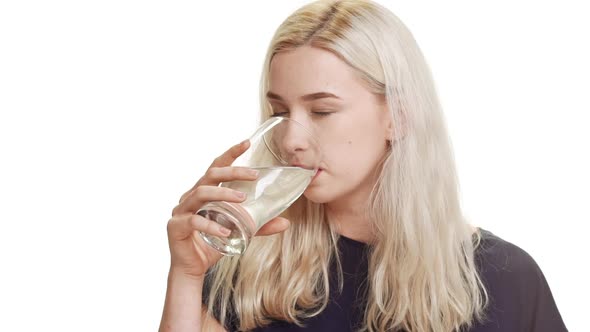 Beautiful Young Caucasian Blonde Teenage Girl in Dark Blue Tshirt Standing on White Background