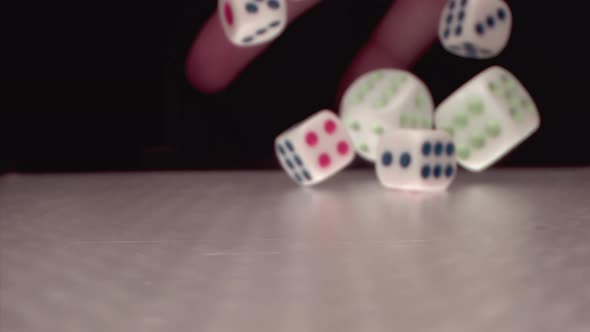 Super Slow Motion of Rolling Gaming Dices on Light White Poker Table