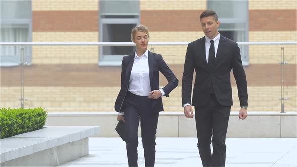 Businessman and Businesswoman Walking on the Street of an Business Center, Slow Motion