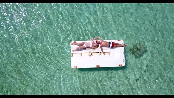 Young couple engaged on idyllic tourist beach wildlife by turquoise water and clean sand background 