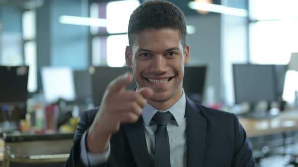 Portrait of African Businessman Pointing Finger and Inviting