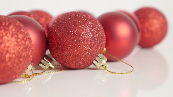 Lot of different Christmas baubles on white 4K tilting footage