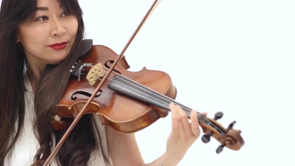 Smiling Asian Woman Playing the Violin on White Background. Close Up