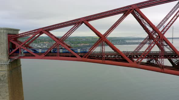 A Train Crossing a Red Bridge in Scotland