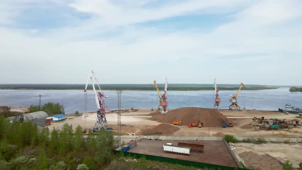 Large Harbor Cranes on the Shore at the Pier