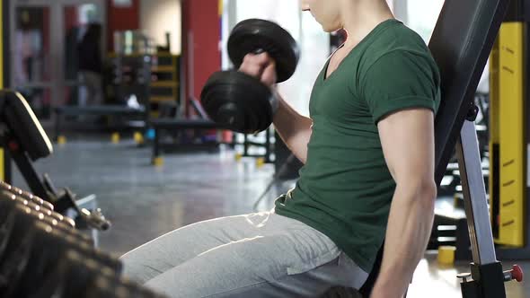 Athlete Lifting Alternately Heavy Dumbbells in Gym Growing Muscles, Bodybuilding