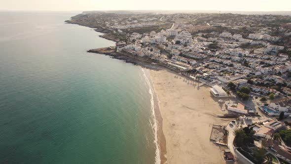 Warm sunny Algarve Beach Praia da Luz shoreline - Aerial fly-over
