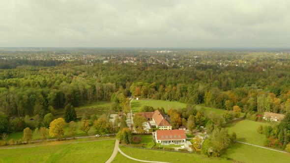 Idyllic living next to a forest captured by a drone. Property with a house next to a forest at fall.