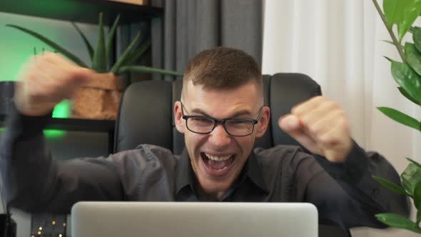 Man is excited by getting job promotion or celebrating success lottery win, celebrating victory