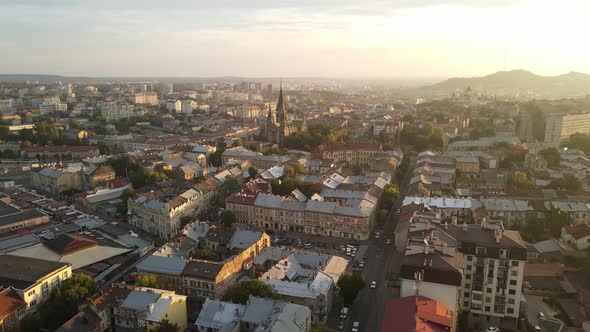 Aerial Flight on a Fabulous City at Sunrise. Morning in the Small Town of Lviv in Ukraine. The Sun's