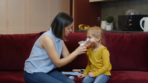 Mother Measuring, Monitoring Oxygen Saturation with Digital Pulse Oximeter of Her Daughter at Home