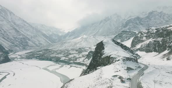 Aerial Cinematic View Of Rugged Hunza Valley Landscape Covered In Snow. Circle Dolly