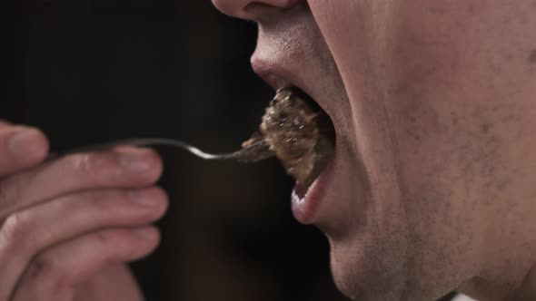 Close Up View of Person Eating Food From Fork