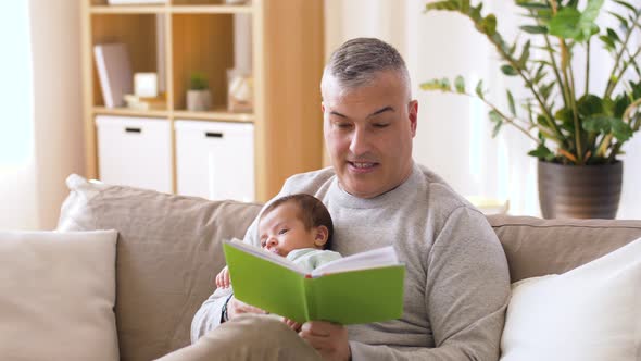 Father Reading Book for Little Baby Boy at Home 24