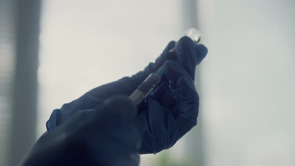 Nurse Hands Preparing Vaccine Dose for Injection Closeup