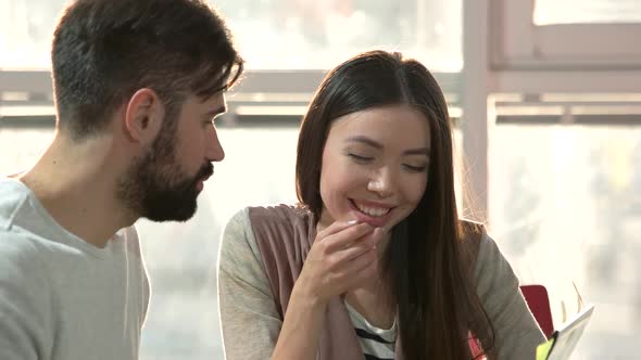 Young Cheerful Couple Having Discussion.