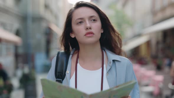 Female Tourist Using Paper Map While Walking at Unknown City